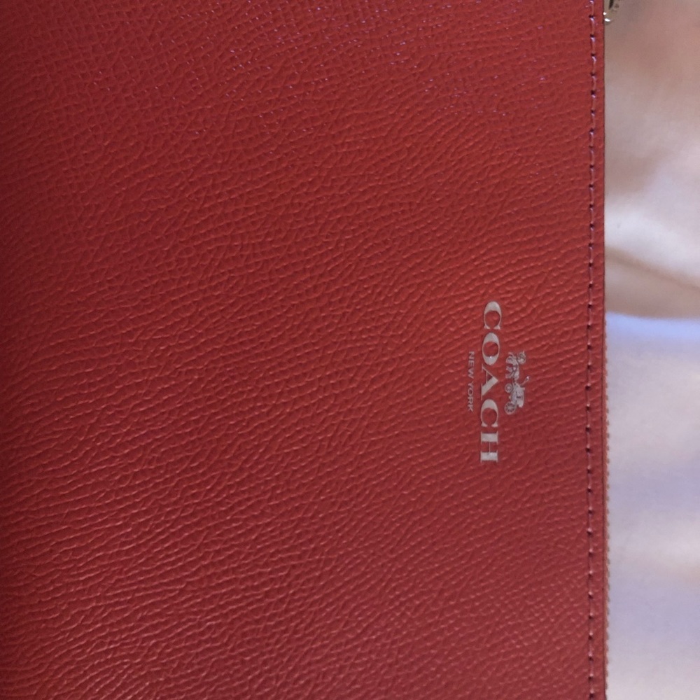 Coach wristlet. NWT. Color-coralish/pink.
